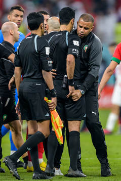 A staff member of Morocco obstructs Referee Abdulrahman Al
