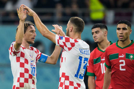 Luka Modric and Nikola Vlasic of Croatia celebrate in front