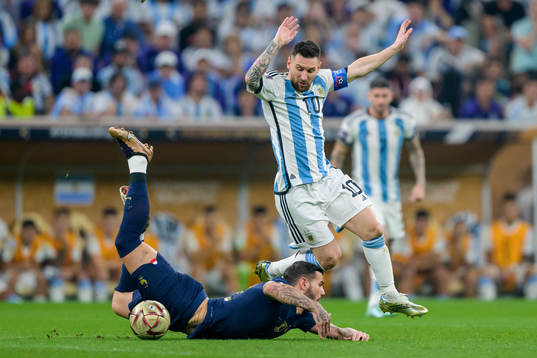 Theo Hernandez of France and Lionel Messi of Argentina