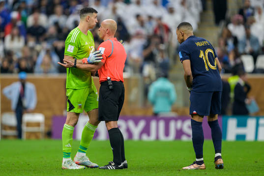 goalkeeper Emiliano Martinez of Argentina and Kylian Mbappe