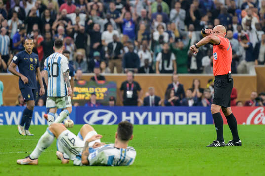 referee Szymon Marciniak signals for a penalty shot for