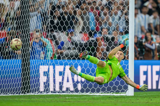 goalkeeper Emiliano Martinez of Argentina as Kylian Mbappe