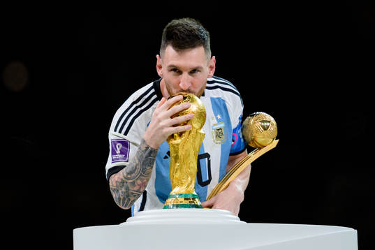 Lionel Messi of Argentina kisses the FIFA World Cup Trophy