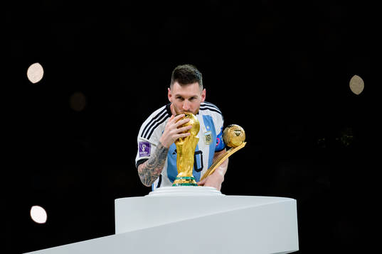 Lionel Messi of Argentina kisses the FIFA World Cup Trophy