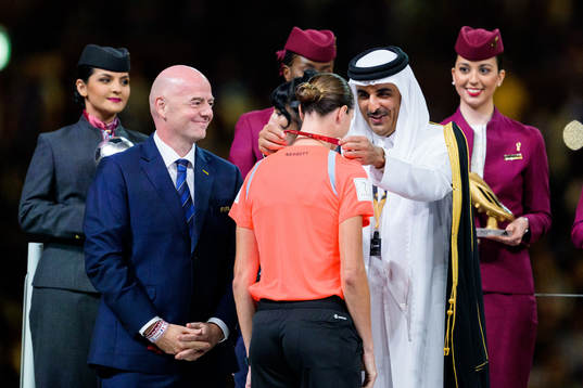 reserve assistant referee Kathryn Nesbitt is given a medal