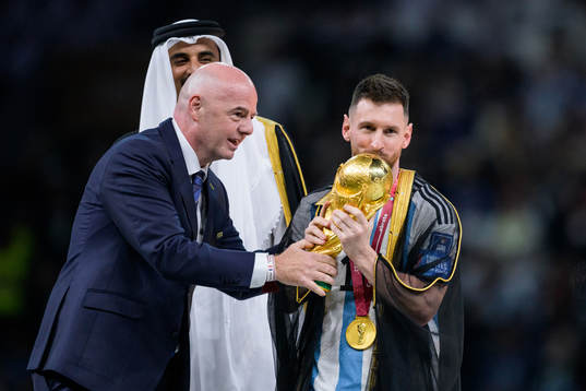 Lionel Messi of Argentina is handed the FIFA World Cup
