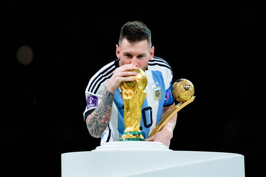 Lionel Messi of Argentina kisses the FIFA World Cup Trophy