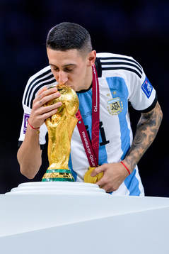 Angel de Maria of Argentina kisses the FIFA World Cup trophy