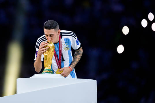 Angel de Maria of Argentina kisses the FIFA World Cup trophy