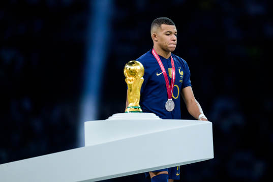 Kylian Mbappe of France looks dejected as he passes the