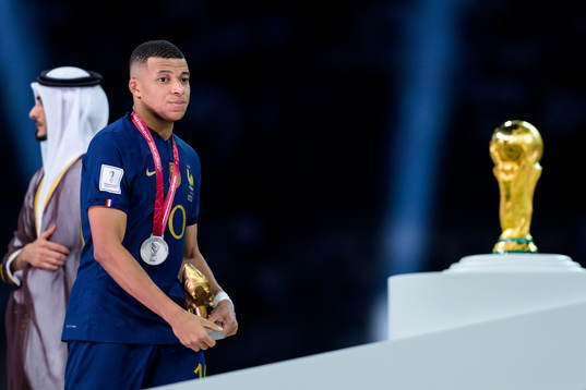 Kylian Mbappe of France looks dejected as he passes the