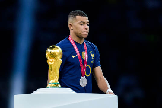 Kylian Mbappe of France looks dejected as he passes the