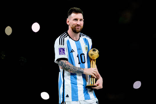 Lionel Messi of Argentina celebrates with his award