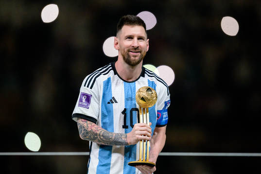 Lionel Messi of Argentina celebrates with his award