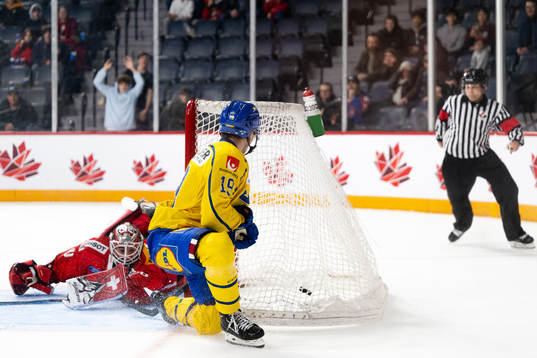 Isak Rosén of Sweden scores a goal behind goaltender Kevin