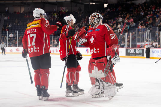 Attilio Biasca and goaltender Kevin Pasche of Switzerland