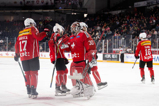 Attilio Biasca and goaltender Kevin Pasche of Switzerland