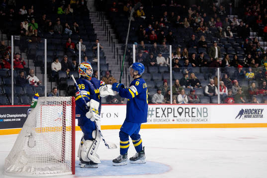 Goaltender Carl Lindbom and Adam Engström of Sweden