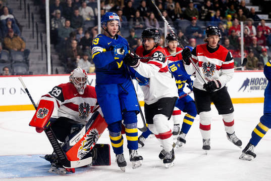 Isak Rosén of Sweden against goaltender Thomas Pfarrmaier