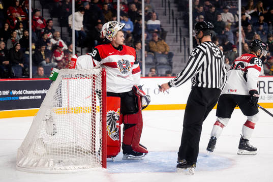 Goaltender Thomas Pfarrmaier of Austria looks dejected the