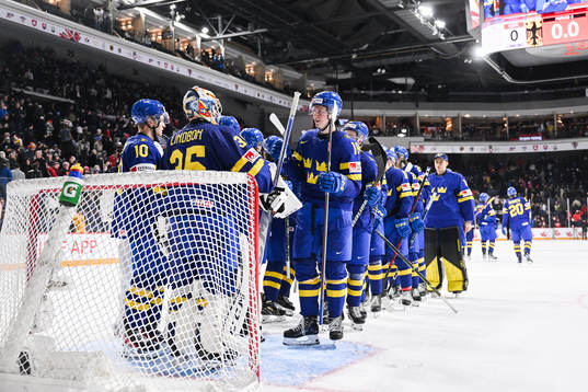 Goaltender Carl Lindbom and Filip Bystedt of Sweden