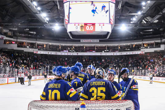 Fabian Wagner and goaltender Carl Lindbom of Sweden