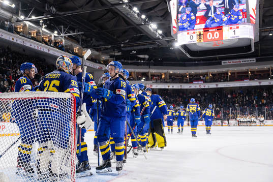 Isak Rosén and goaltender Carl Lindbom of Sweden celebrate