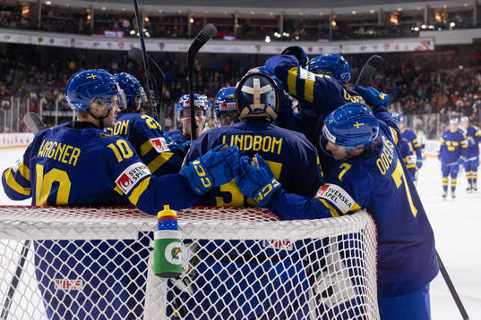 Players of Sweden celebrate with goaltender Carl Lindbom