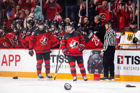 Shane Wright and Connor Bedard of Canada celebrate the 5-1