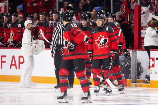Connor Bedard and Logan Stankoven of Canada celebrate the