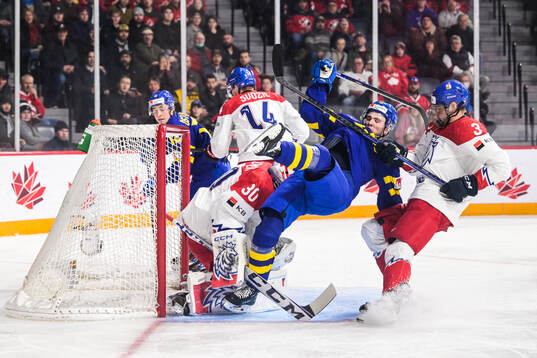 Isak Rosén of Sweden against goaltender Tomas Suchanek and