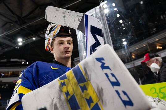 Goaltender Carl Lindbom of Sweden celebrates