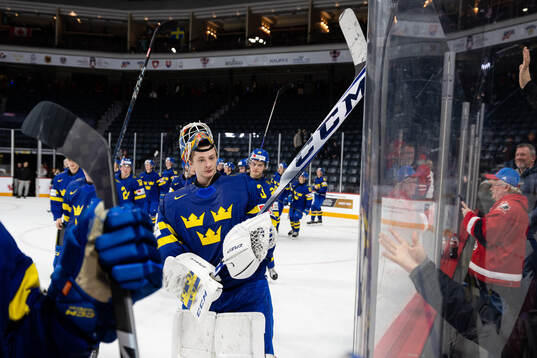 Goaltender Carl Lindbom of Sweden celebrates