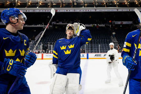 Goaltender Carl Lindbom of Sweden celebrates