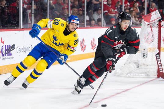 Simon Robertsson of Sweden and Dylan Guenther of Canada