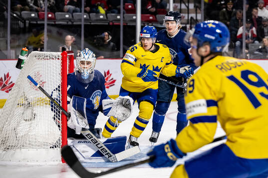 Victor Stjernborg of Sweden against goaltender Jani