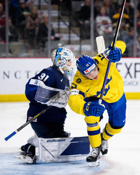 Noah Östlund of Sweden against goaltender Jani Lampinen of