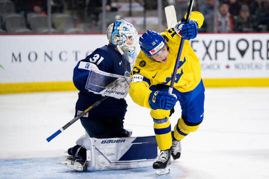 Noah Östlund of Sweden against goaltender Jani Lampinen of