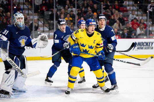 Victor Stjernborg of Sweden against goaltender Jani