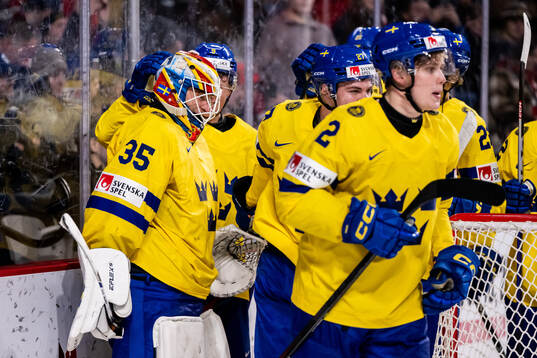 Players of Sweden celebrate with goaltender Carl Lindbom