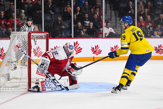 Isak Rosén of Sweden and goaltender Tomas Suchanek of
