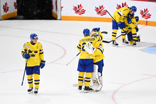 Oskar Pettersson and goaltender Carl Lindbom of Sweden look