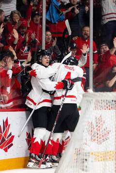 Ethan Del Mastro and Connor Bedard of Canada celebrates the