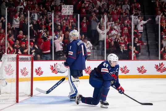 Luke Hughes and goaltender Trey Augustine  of USA look