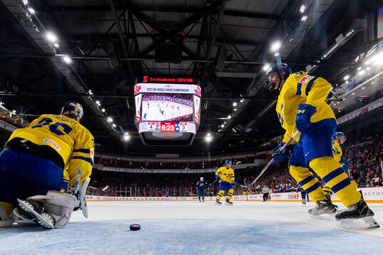 Goaltender Carl Lindbom and Axel Sandin-Pellikka of Sweden