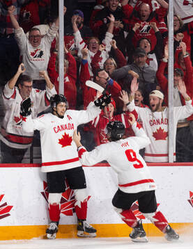 Dylan Guenther and Joshua Roy of Canada celebrate the game