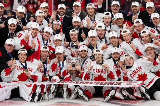 Players  of Canada celebrate with the trophy