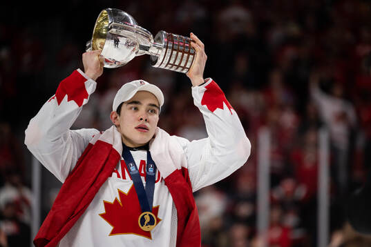 Olen Zellweger of Canada celebrates with the trophy