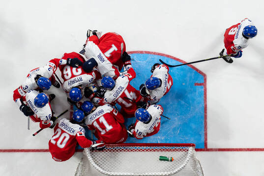 Players of Czech Republic gathered with goaltender Tomas
