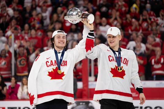 Colton Dach of Canada celebrates with the trophy